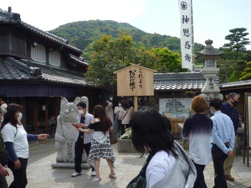 a group of people standing in front of a temple at Futami Terrace B in Ise