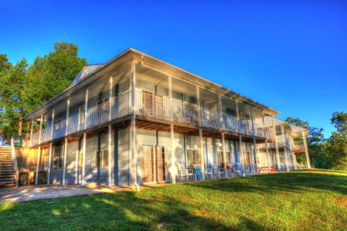 a large house with a large lawn in front of it at Crown Lake Resort in Horseshoe Bend