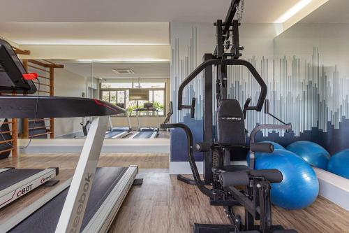 a gym with a treadmill and blue gym balls at Vossa Bossa Vila Madalena in Sao Paulo