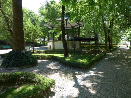 a park with a bench and a tree at Casa da Rua Nova in Castelo de Vide