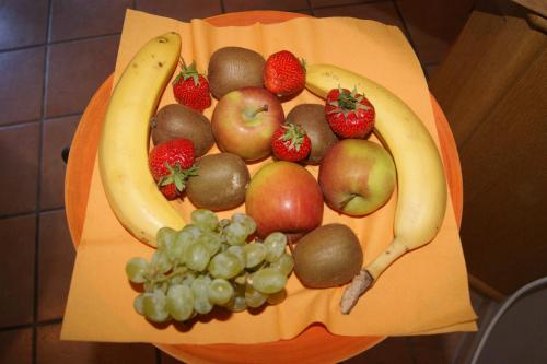 a plate of fruits and vegetables on a table at Pension Heib in Cochem