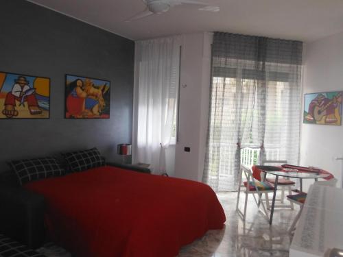 a bedroom with a red bed and a table at Green Quercia Apartment in Como