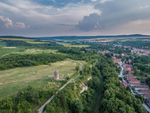 an aerial view of a small village in a field with a river at Dorci Vendégház - A piece of peace in Cserépfalu