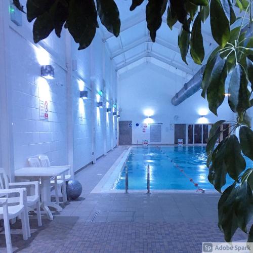 a large swimming pool in a large building at Bay Retreat Apartment The Bay Holiday Village Filey Homesweetholidayhomes in Filey