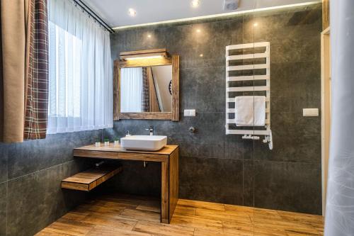 a bathroom with a sink and a mirror at Osada Wierchlove Domki in Bustryk