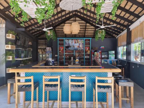 a bar in a restaurant with a blue counter and stools at Hotel Sea Breeze Sosua in Sosúa