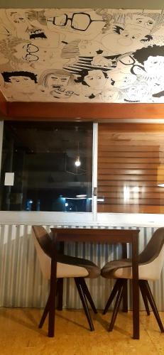 a table and two chairs in a room at Bucanaan hostel boutique in Cordoba