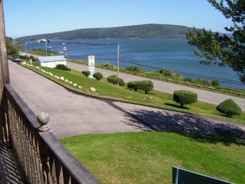 a balcony with a view of a road and the water at Admiral Digby Inn Restaurant and Cottages in Digby