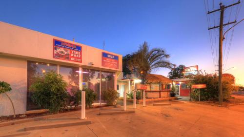 a building with signs in front of it on a street at Townview Motel in Mount Isa