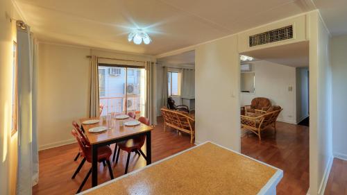 a dining room and living room with a table and chairs at Townview Motel in Mount Isa