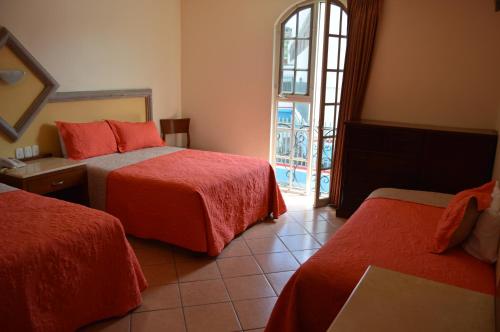 Ένα ή περισσότερα κρεβάτια σε δωμάτιο στο Hotel Real Santa Fe