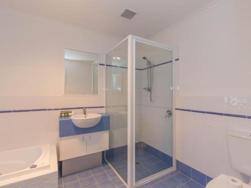 a bathroom with a sink and a shower and a toilet at Silvertrees 2 1 McLure Cir in Jindabyne