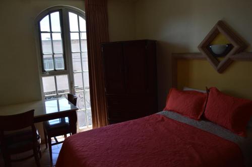 Ένα ή περισσότερα κρεβάτια σε δωμάτιο στο Hotel Real Santa Fe