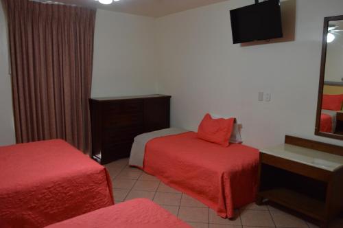 Ένα ή περισσότερα κρεβάτια σε δωμάτιο στο Hotel Real Santa Fe