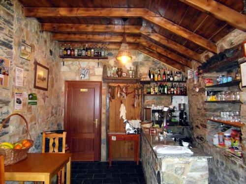 una cucina con bancone in una stanza con pareti in pietra di Casa de Lucas a Fonfría
