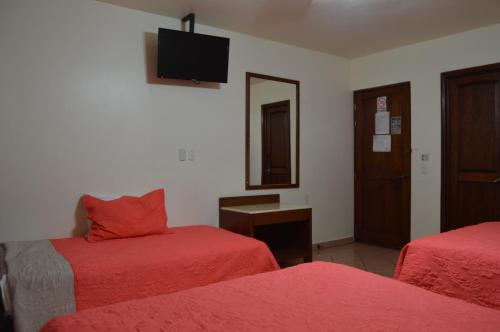Ένα ή περισσότερα κρεβάτια σε δωμάτιο στο Hotel Real Santa Fe