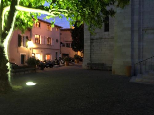 a group of buildings in a courtyard with a tree at Le petit clocher de Cassis in Cassis