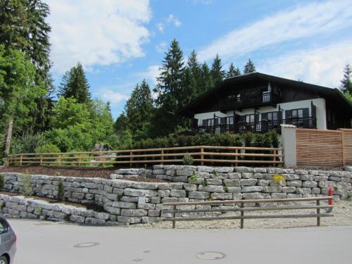 a stone retaining wall in front of a house at Ferienhaus Heimhof in Garmisch-Partenkirchen