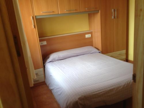 a small bedroom with a bed in a small room at Apartaments la Fabrica in Horta de San Joan
