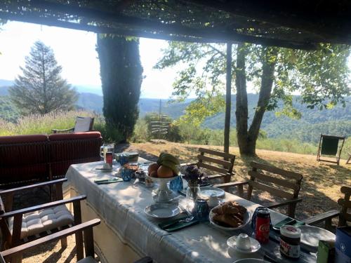 a table with food on it with a view at Cottage with swimming pool in Misciano