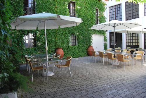 a group of tables and chairs with umbrellas at Rio NaturAL in Vila Nova de Milfontes