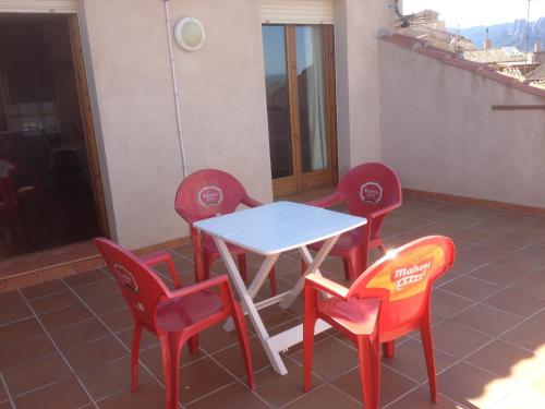 a table and chairs on a balcony with a table and chairs at Apartaments la Fabrica in Horta de San Joan