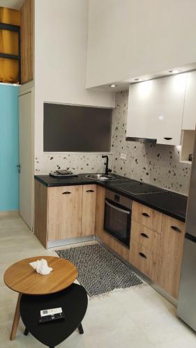 a kitchen with a stove and a table in it at LEFKAS CITY APARTMENTS & Suites in Lefkada Town