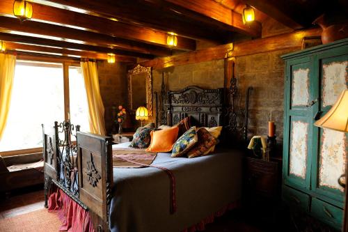 a bedroom with a bed in a room with wooden walls at Hacienda Rumiloma in Quito
