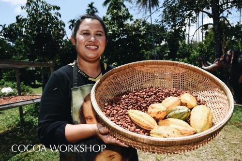 Eine Frau hält einen Korb mit Essen. in der Unterkunft Madison Hotel in Nakhon Si Thammarat