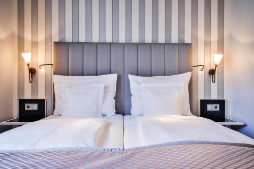 Uma cama ou camas num quarto em Sylthotel Raffelhüschen Garni