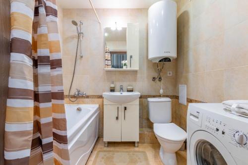 a bathroom with a toilet and a sink and a shower at Апартаменты Гостиный Дворъ и Ко Автовокзал in Yekaterinburg