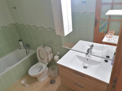 a bathroom with a toilet and a sink at Casa Gaia in Las Playitas
