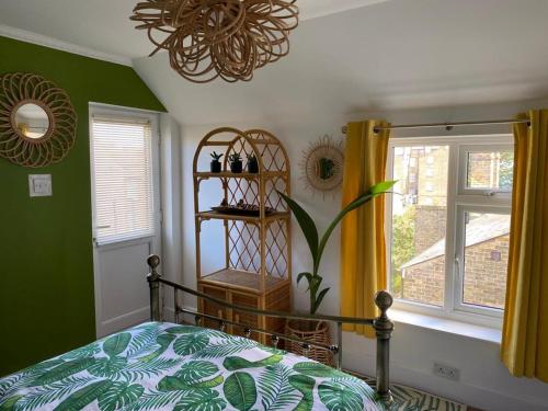 a bedroom with a bed and a window at Lovely 1 bed split level flat in Ramsgate in Kent