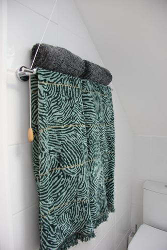 a towel hanging on a wall in a bathroom at Lovely 1 bed split level flat in Ramsgate in Kent