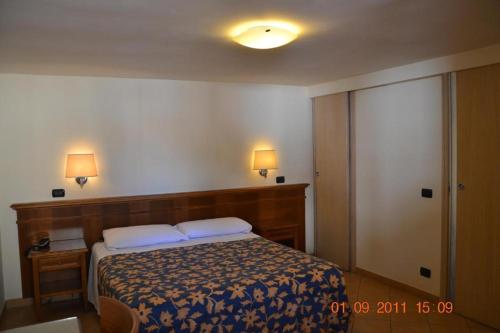 a bedroom with a bed with two pillows on it at Hotel La Locanda Del Borgo in Casal Monastero