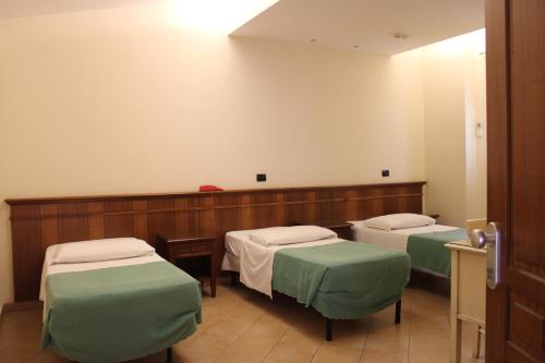 a hospital room with two beds and two chairs at Hotel La Locanda Del Borgo in Casal Monastero