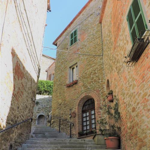 an alley with stairs in an old stone building at Boutique Hotel Masolino in Panicale