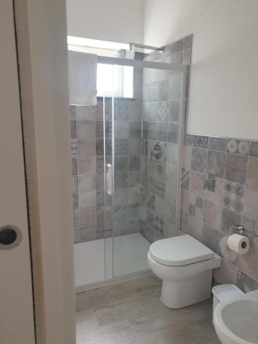 a bathroom with a shower with a toilet and a sink at graziosa villetta III in Lampedusa