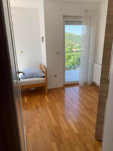 a bedroom with a bed and a large window at Ferienhaus in Široki Brijeg