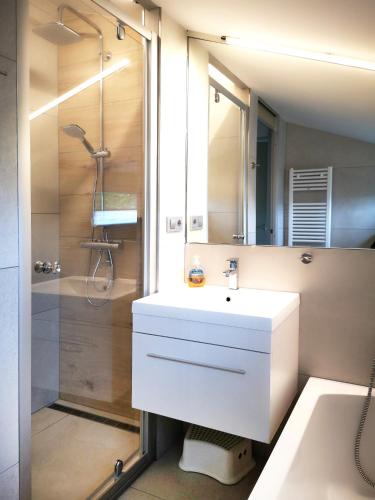 a bathroom with a white sink and a shower at Ferienhaus IRENE in Meschede