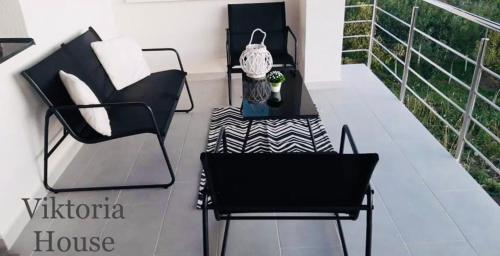 a balcony with a chair and a table and a chair at Viktoria House in Odorheiu Secuiesc