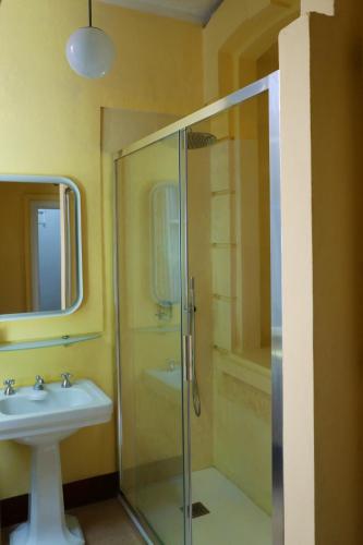 a bathroom with a glass shower and a sink at Villino liberty in Cernobbio