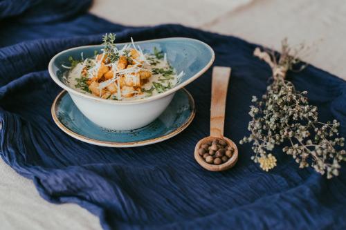 a bowl of food on a table with a blue table cloth at Gold Hotel in Złotoryja