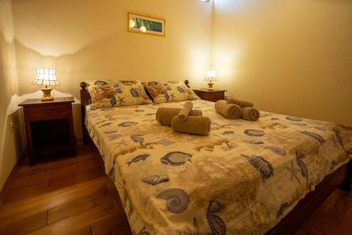 a bedroom with a bed with pillows on it at Villa Flaveico in Pašman