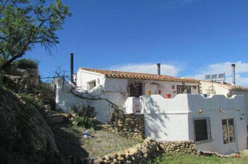 a white house with a fence in front of it at Cortijo tranquilo, Albanchez, Almeria Province in Albánchez