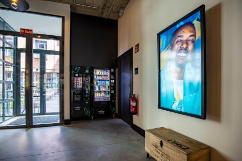 a large screen television on the wall of a building at The Central House Madrid Lavapiés in Madrid