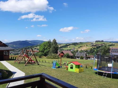 a backyard with a playground with a play equipment at Domki na Beskidzie 1861 in Istebna