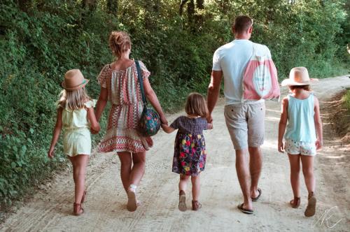 a family of three walking down a dirt road at Domaine d'Escapa in Estipouy