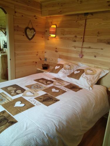 a bed in a room with hearts on it at Au Paradou du Bûcheron Adults only in Lessive