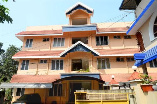 een groot gebouw met een rood dak bij Andoor Homes, Apt 2D in Trivandrum